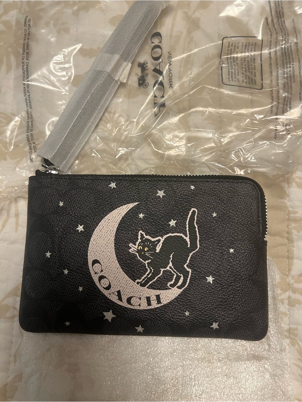 COACH Black Leather Wristlet with Moon & Cat Graphic